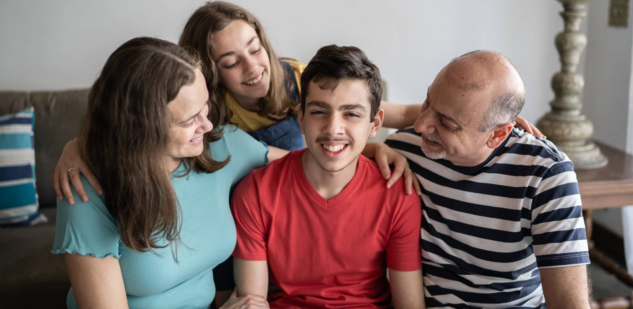 Young male group home resident with his family